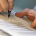 Man's Hands Signing Document --- Image by © Royalty-Free/Corbis